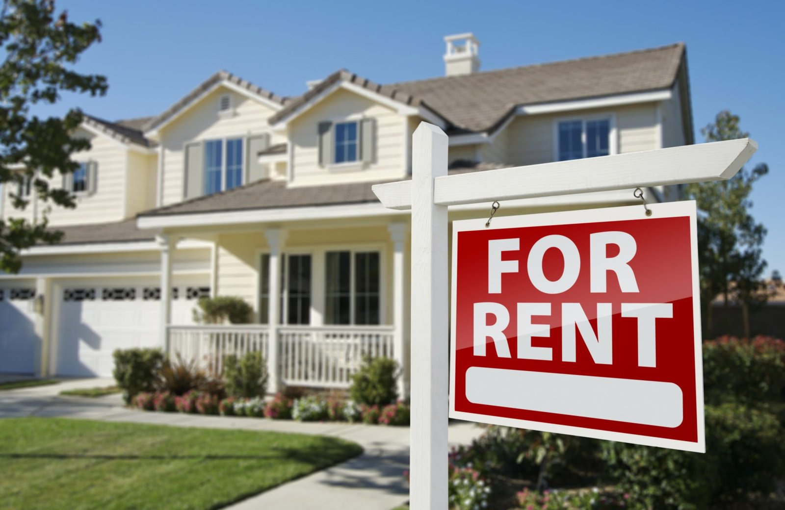 Left Facing Red For Rent Real Estate Sign in Front of Beautiful House.